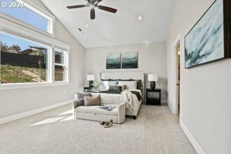 carpeted bedroom featuring ceiling fan and high vaulted ceiling