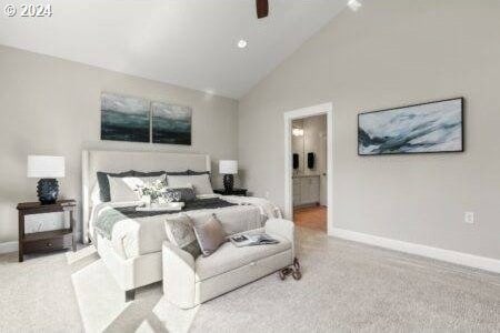 carpeted bedroom featuring ceiling fan, high vaulted ceiling, and ensuite bathroom