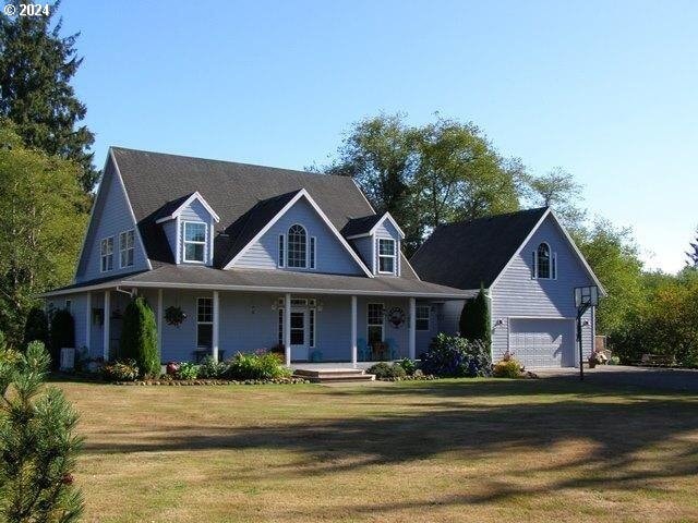 view of front of property with a garage, a porch, and a front yard