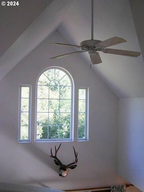 bonus room with a wealth of natural light, ceiling fan, and vaulted ceiling