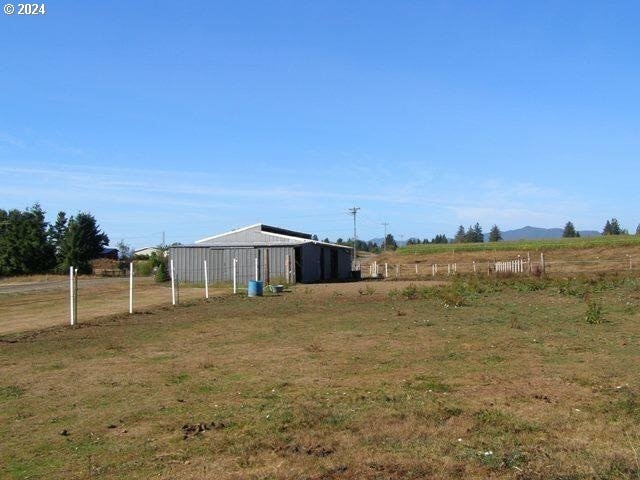 view of yard with a rural view