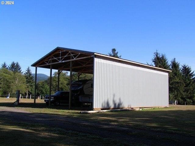 view of shed / structure featuring a lawn and a carport