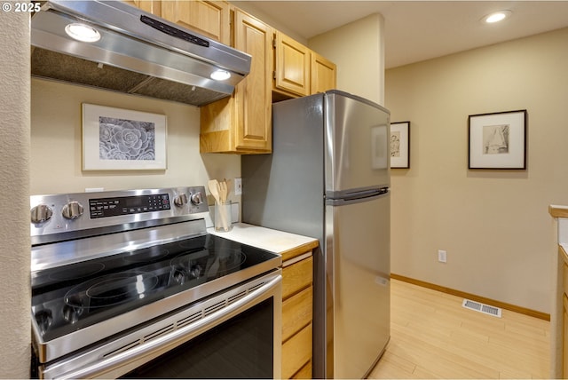 kitchen featuring light brown cabinets, light wood-type flooring, stainless steel appliances, and exhaust hood