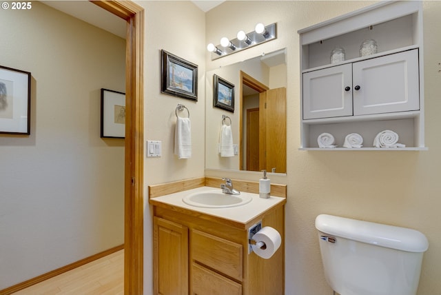 bathroom featuring hardwood / wood-style flooring, vanity, and toilet