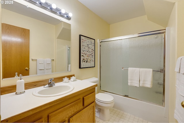 full bathroom with vanity, toilet, and combined bath / shower with glass door