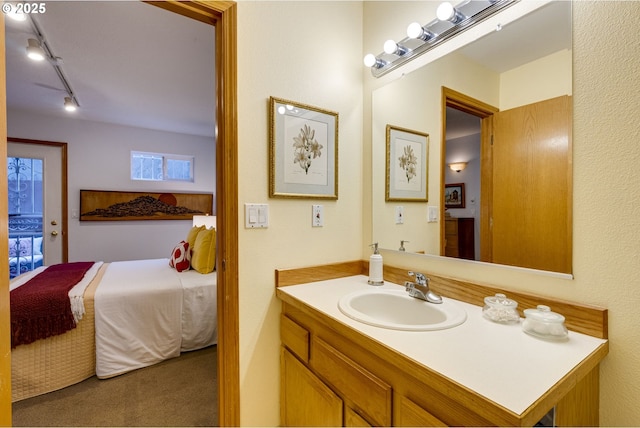 bathroom with vanity and track lighting