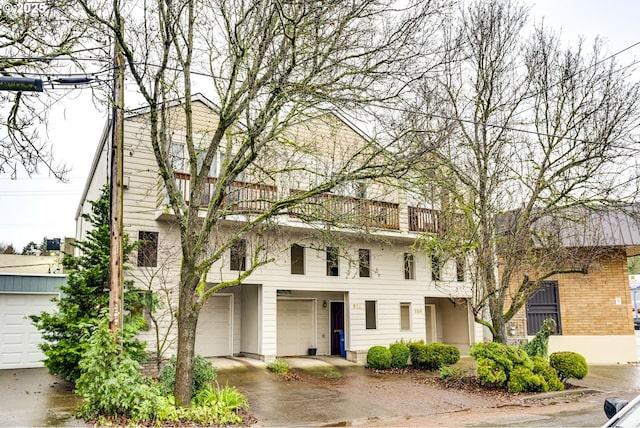 townhome / multi-family property featuring a garage and a balcony