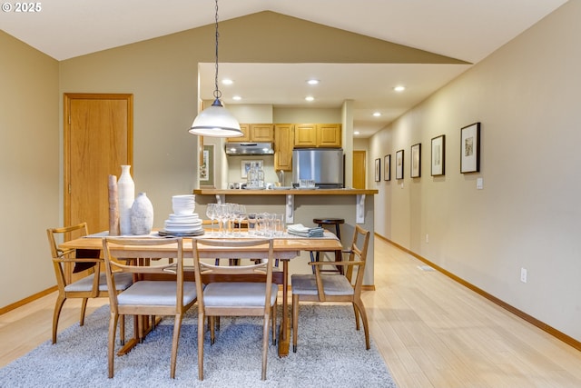 dining space with vaulted ceiling