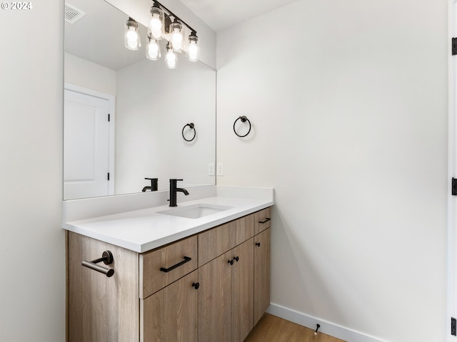 bathroom with vanity and hardwood / wood-style floors