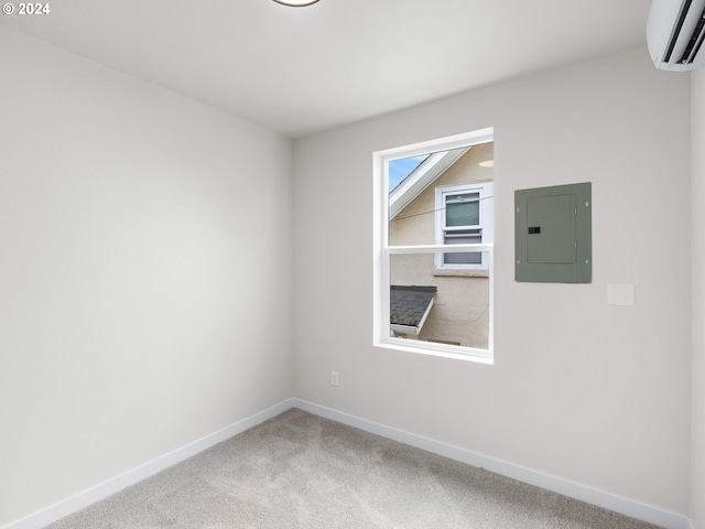 empty room featuring a wall unit AC, electric panel, and carpet floors