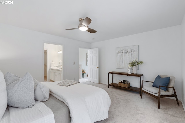 bedroom with light carpet, connected bathroom, and ceiling fan