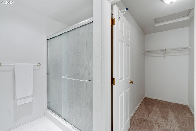 bathroom featuring a shower with door