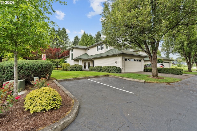 front facade with a front yard and a garage