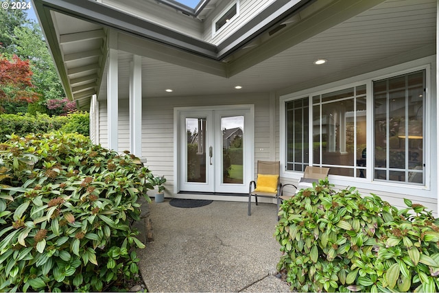 view of exterior entry featuring french doors and a patio