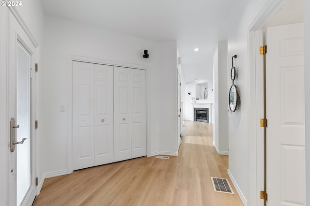 corridor with light wood-type flooring