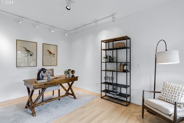 office area featuring light wood-type flooring and rail lighting