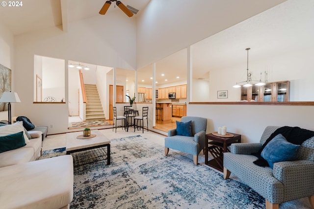 living room featuring beam ceiling, high vaulted ceiling, and ceiling fan