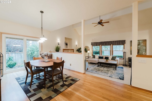 dining room featuring ceiling fan, hardwood / wood-style floors, and high vaulted ceiling