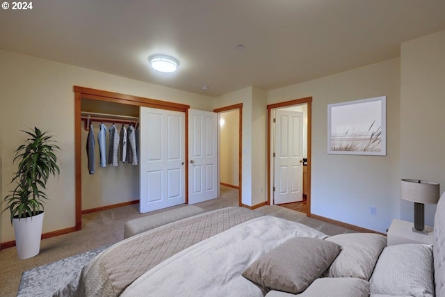 bedroom with light carpet and a closet