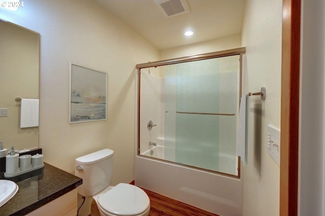 full bathroom with toilet, combined bath / shower with glass door, vanity, and hardwood / wood-style floors