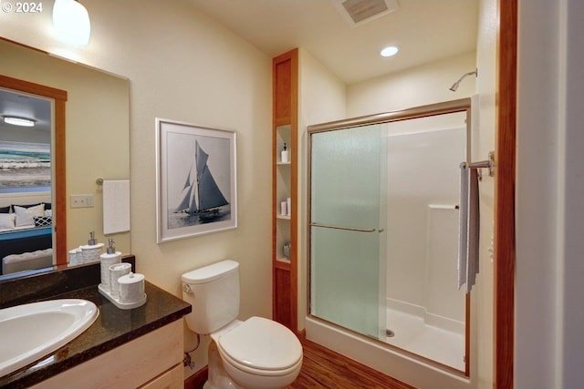720 G Ave Unit D, Seaside, OR 97138 - bathroom featuring a shower stall, vanity, toilet, and wood finished floors