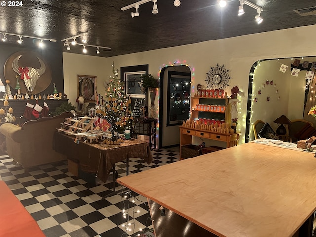 interior space featuring visible vents, rail lighting, and tile patterned floors