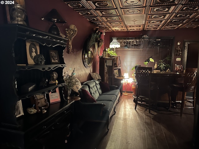 living room with an ornate ceiling and hardwood / wood-style flooring