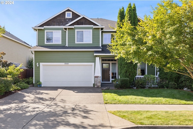 view of front of house featuring a front yard and a garage