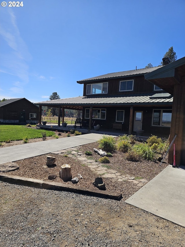 view of front of home with covered porch and metal roof