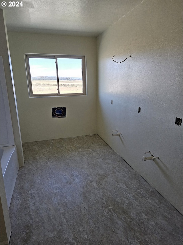 empty room featuring a textured ceiling