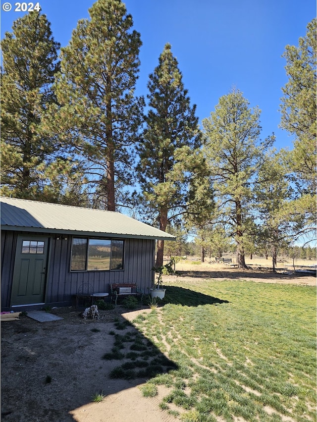 view of side of property with a yard