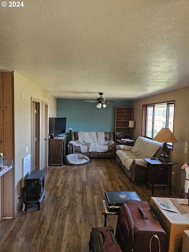 living area featuring a ceiling fan, a textured ceiling, and wood finished floors