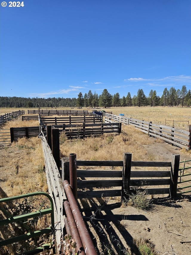 view of yard with a rural view and fence