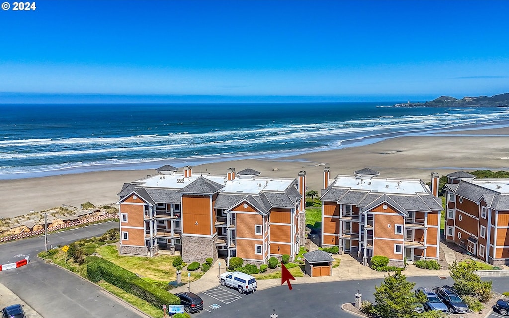 bird's eye view with a water view and a view of the beach