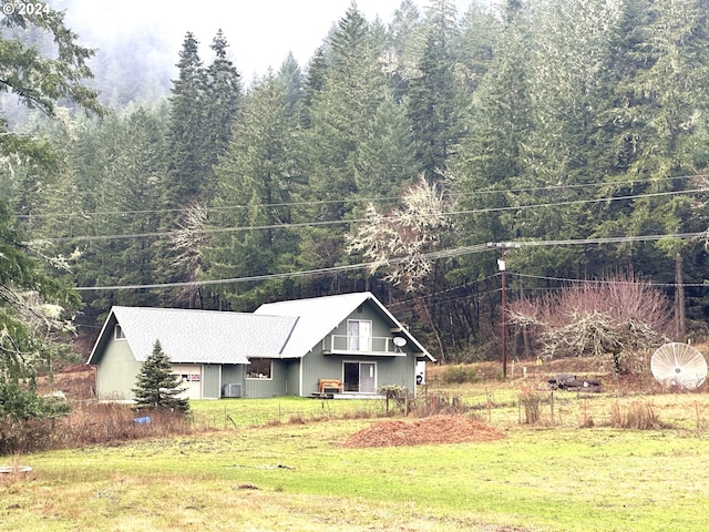 view of front of house with central air condition unit and a front yard