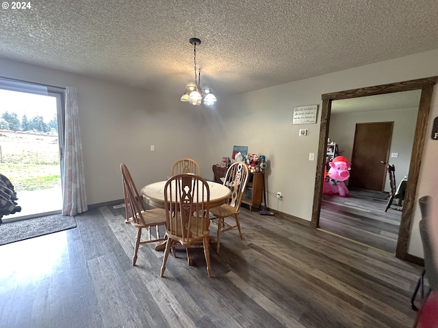 dining room featuring a textured ceiling, dark hardwood / wood-style floors, and a notable chandelier