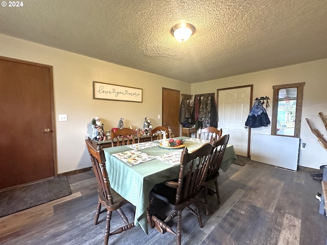 dining space with dark wood-type flooring and a textured ceiling