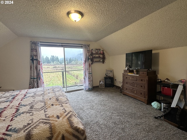 carpeted bedroom with a textured ceiling and vaulted ceiling