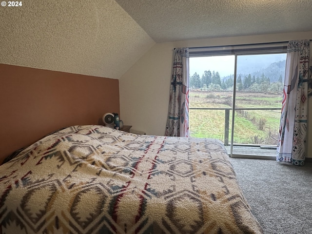 bedroom featuring carpet, a textured ceiling, and vaulted ceiling
