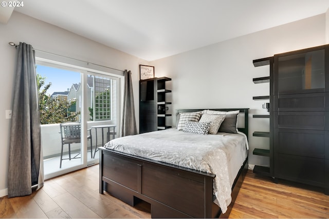 bedroom with access to exterior and light hardwood / wood-style floors