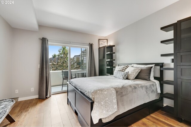 bedroom featuring light hardwood / wood-style floors and access to outside