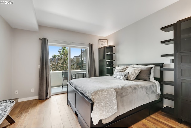 bedroom featuring access to exterior and light hardwood / wood-style floors