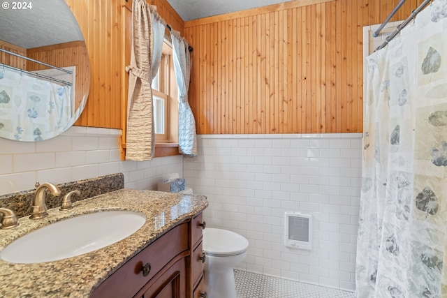 bathroom with tile walls, wood walls, a textured ceiling, and toilet