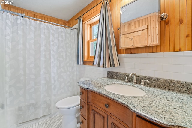 bathroom featuring tile patterned floors, vanity, curtained shower, and toilet