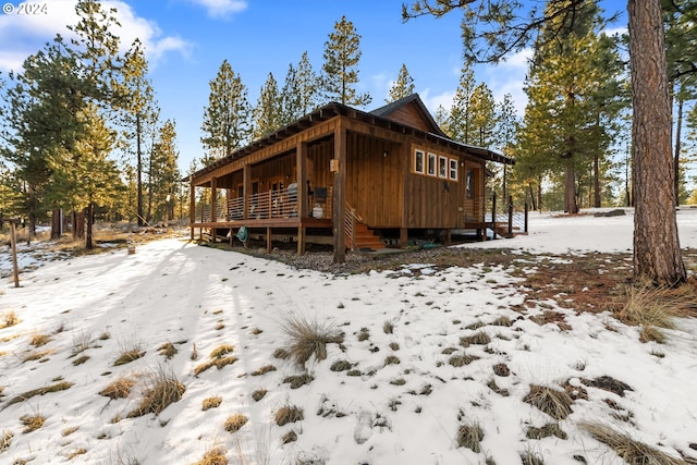 view of snowy exterior featuring a deck