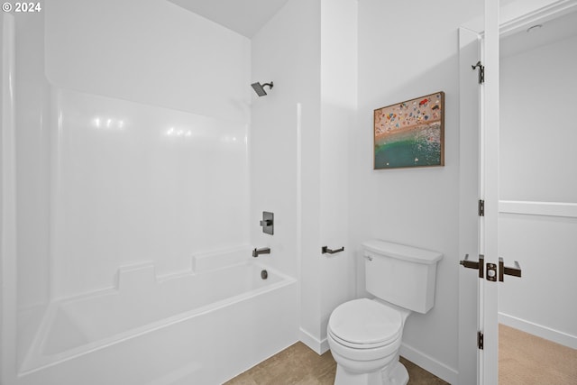 bathroom featuring toilet and bathing tub / shower combination