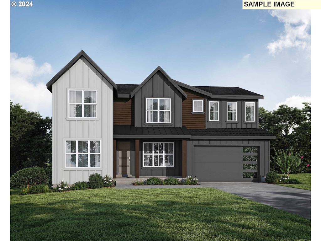 view of front of home with a garage and a front lawn