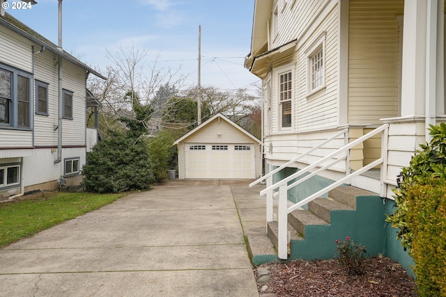 view of side of home featuring a garage and an outdoor structure