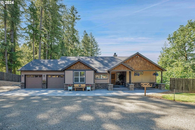 view of front of house with covered porch and a garage