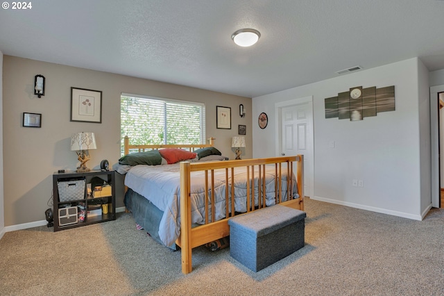 bedroom featuring carpet floors and a textured ceiling